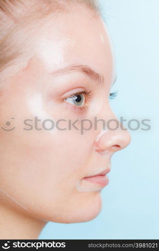 Close up young woman in facial peel off mask. Peeling. Beauty and skin care. Side view. Close up woman in facial peel off mask.