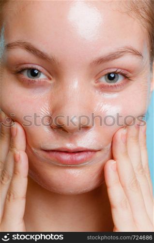 Close up young woman in facial peel off mask. Peeling. Beauty and skin care.. Close up woman in facial peel off mask.