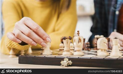 close up young woman playing chess board game. High resolution photo. close up young woman playing chess board game. High quality photo