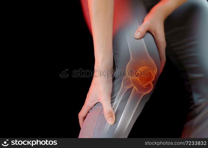 Close up young woman suffering from pain in knee.