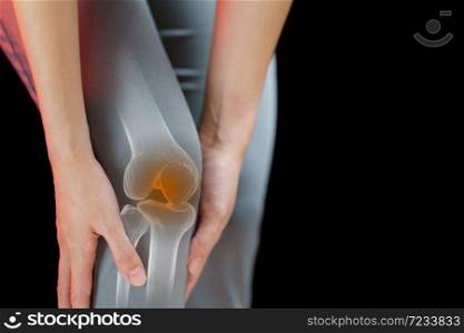 Close up young woman suffering from pain in knee.