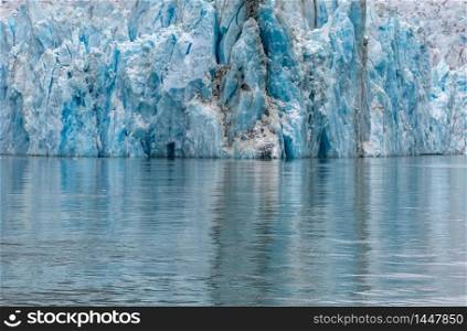 Close view of a glacier and its reflection in the water