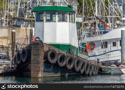Close view of a tugboat docked in a marina in Sitka, Alaska, USA