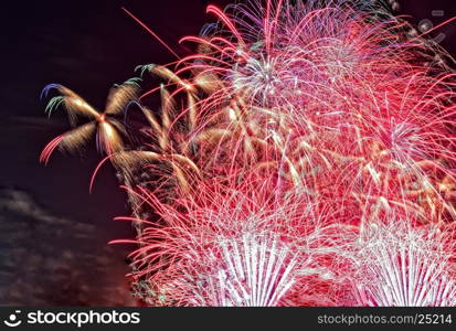 Close view of colorful bouquets of fireworks in the night sky on the night of 31 December to 1 January. close, horizontal view.i