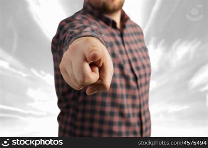 Close view of man in casual pointing with finger to camera. Make your choice