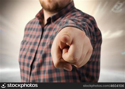 Close view of man in casual pointing with finger to camera. Make your choice