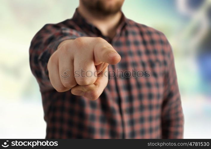 Close view of man in casual pointing with finger to camera. Make your choice