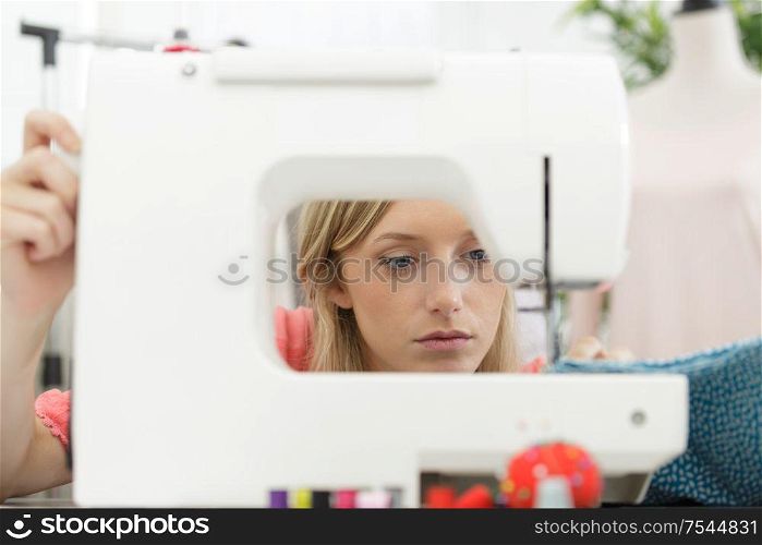 close view of woman seen through sewing machine