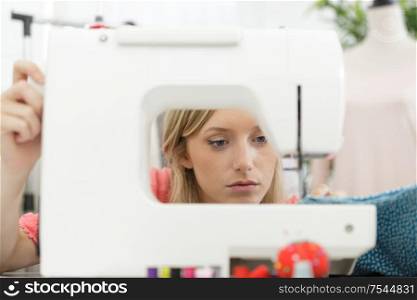 close view of woman seen through sewing machine