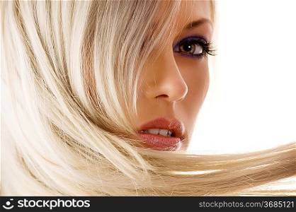 close_up of face of pretty girl with long blond hair watching in camera