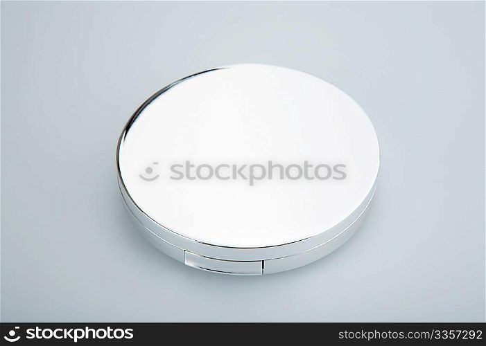 Closed cosmetic mirror on a white background