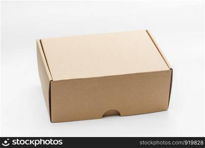 Closed empty cardboard box isolated on a white background, craft boxing. Closed empty cardboard box isolated on a white background