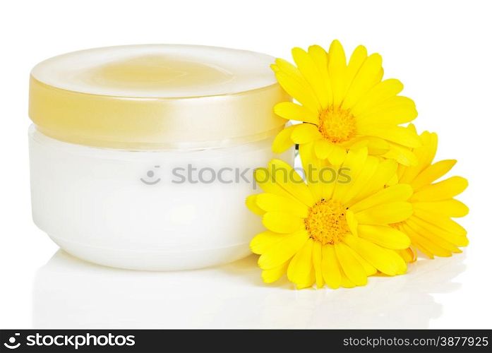 Closed jar of cream and three orange calendula flowers isolated on a white background