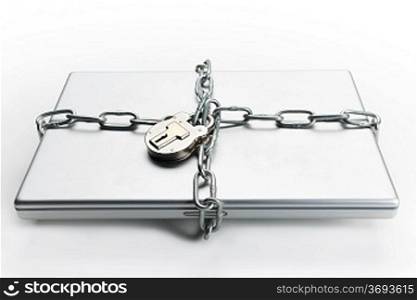 Closed laptop computer with chain wrapped around it and padlocked