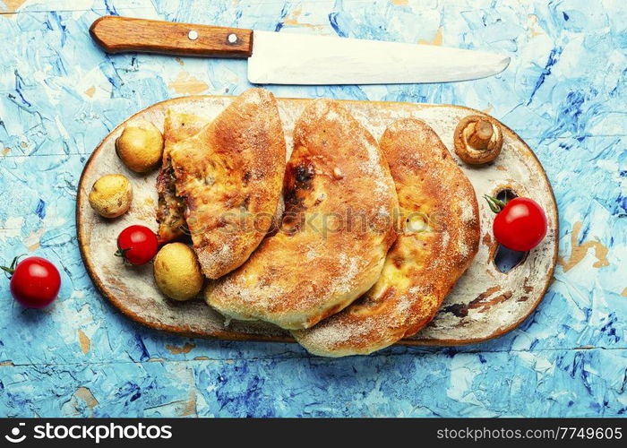 Closed pizza with mushrooms. Calzone - Italian pie. Calzone - Italian pie, pizza
