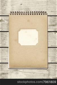 Closed spiral Note book on a white wood table. Mockup. Closed spiral Note book on a white wood table
