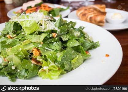 Closed up caesar salad served on wooden table, stock photo