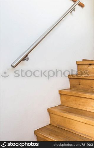 closed up of wooden stairs and railing in a home, details of a modern house, modern. closed up of wooden stairs and railing in a home, details of a modern house