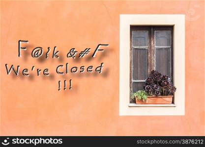 Closed window with planter and orange wall with written.