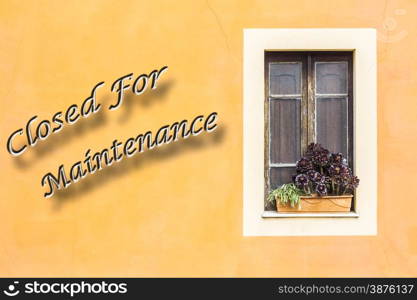 "Closed window with planter and yellow wall with written "closed For Maintenance""