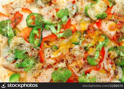 Closeuo of grilled teriyaki chicken with red bell pepper, garlic, mild jalapeno pepper, broccoli, tomato, shrarp cheddar and fresh parmesan cheese. Pizza Closeup