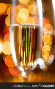 Closeup abstract photo of champagne glass with reflecting Christmas lights