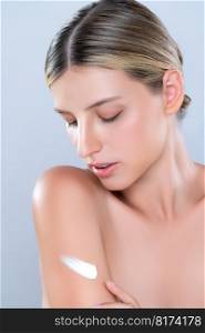 Closeup alluring beautiful woman applying moisturizer cream on her arm for perfect skincare treatment in isolated background. Caucasian women portrait with skin rejuvenation and cosmetology concept.. Closeup alluring beautiful woman applying moisturizer cream on her arm concept.