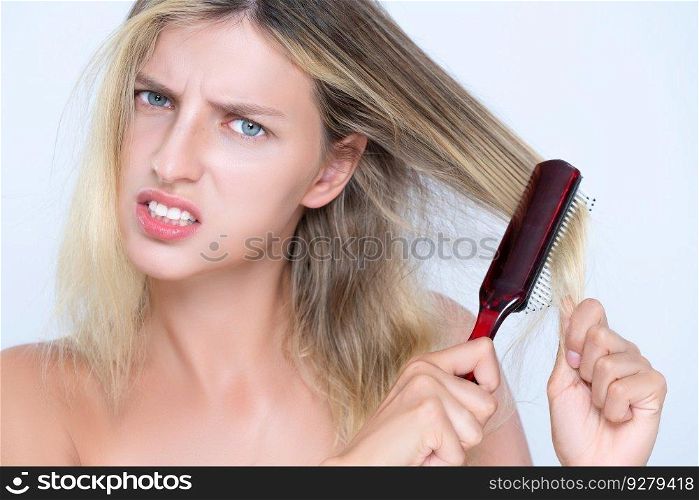 Closeup alluring portrait of beauty cosmetic clean skin woman having brittle dry hair problem. Grimacing frustrated sad facial expression in isolated background. Damaged and hair loss concept.. Closeup alluring woman portrait with cosmetic skin having hair loss problem.