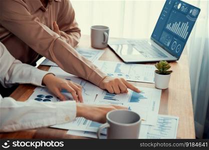 Closeup analyst team colleagues discuss financial data on digital dashboard, analyzing charts and graph with supportive teamwork. Professional office use BI to plan marketing business. Enthusiastic. Analyst team colleague discuss financial data on digital dashboard. Enthusiastic