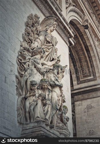 Closeup architectural details of the triumphal Arch, Paris, France. The peace statue  La Paix de 1815  adorns a pillar of the Arc de Triomphe with goddess of victory Minerva