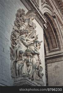 Closeup architectural details of the triumphal Arch, Paris, France. The peace statue  La Paix de 1815  adorns a pillar of the Arc de Triomphe with goddess of victory Minerva