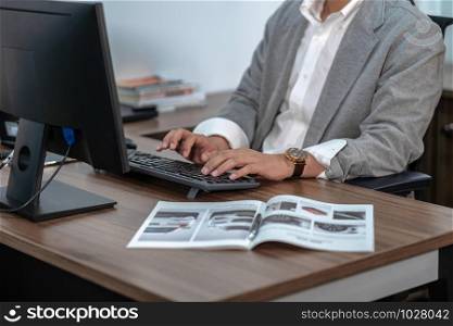 Closeup Asian Businessman in formal suit hand typing computer keyboard in office, business and technology workplace concept