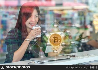 Closeup Asian businesswoman hand using technology tablet with Bitcoins mockup and Distributed computer network hologram in workplace co-working space,blockchain and bitcoin concept