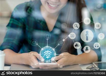 Closeup Asian businesswoman hand using the smart mobile phone with happiness action for online shopping with omni channel on the desk beside the glass in workplace, business lifestyle concept