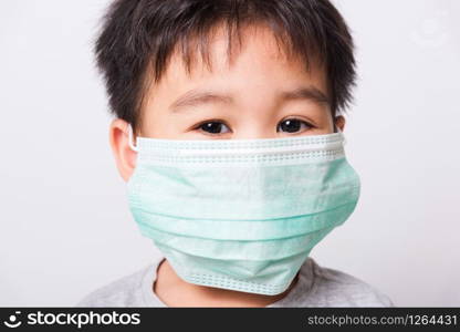 Closeup Asian face, Little children boy sick he using medicine healthcare mask on white background with copy space, health medical care