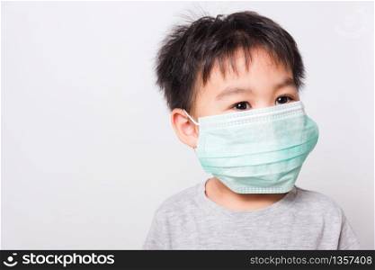 Closeup Asian face, Little children boy sick he using medicine healthcare mask on white background with copy space, health medical care