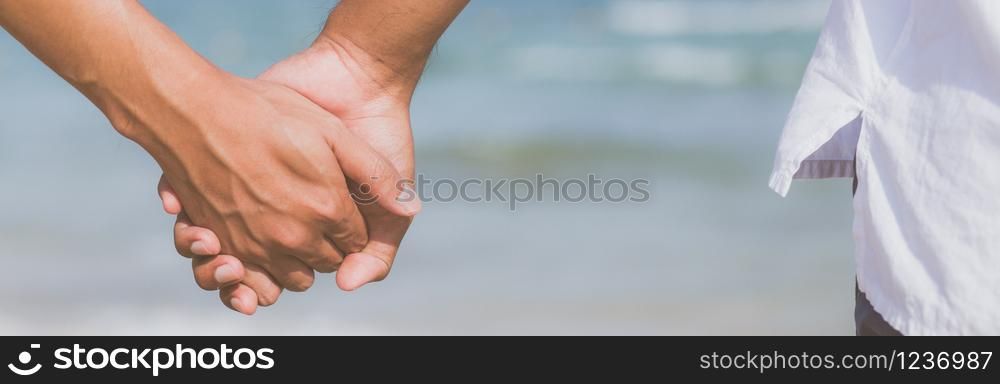 Closeup asian gay couple holding hands together on the beach with relax and leisure in summer, LGBT homosexual legal two romantic in vacation, relationship sex lover concept, banner website.