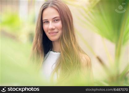 Closeup authentic portrait of a nice female in the park, fresh natural appearance of youthful girl, happy lifestyle of young people. Authentic woman portrait