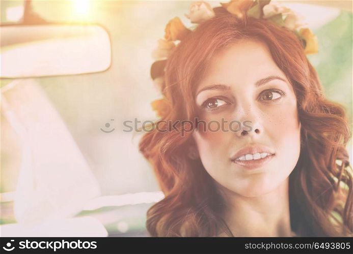 Closeup authentic portrait of a nice redhead female with freckles wearing floral wreath, natural beauty of Slavonian women, photo with bright sun flare. Authentic womens portrait
