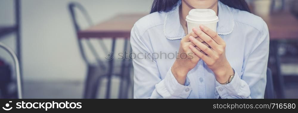 Closeup banner web young asian woman drinking coffee and in the morning at cafe, girl sitting in coffee shop for breakfast and leisure during free time.