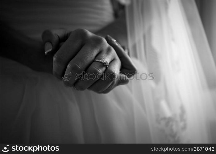 Closeup black and white photo of brides hands with beautiful manicure