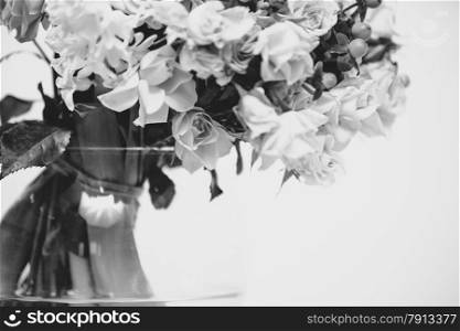 Closeup black and white photo of flowers standing in vase