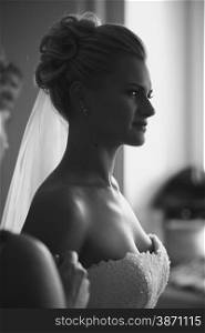 Closeup black and white portrait of young beautiful bride at home
