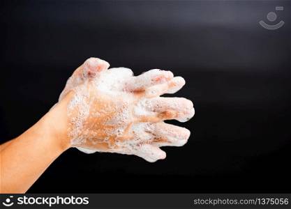 Closeup body care Asian young woman washing hands with soap have foam, hygiene prevention COVID-19 or coronavirus protection concept, isolated on black background