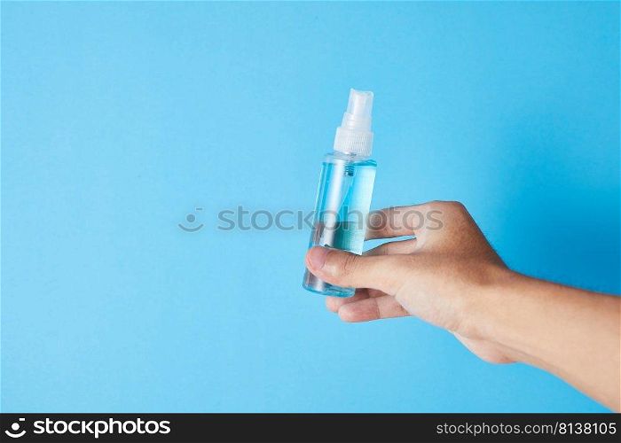 Closeup bottle of blue alcohol hand spray. corona virus concept . Closeup bottle of blue alcohol hand spray.