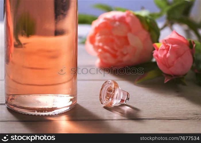 Closeup Bottle Of Pink Rose Wine and Spring Flowers