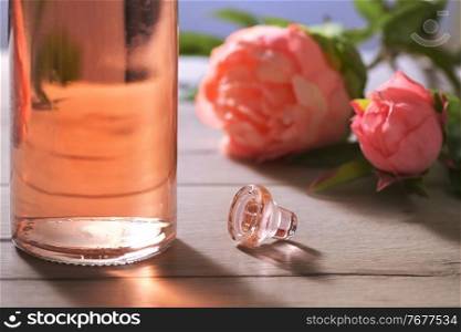 Closeup Bottle Of Pink Rose Wine and Spring Flowers