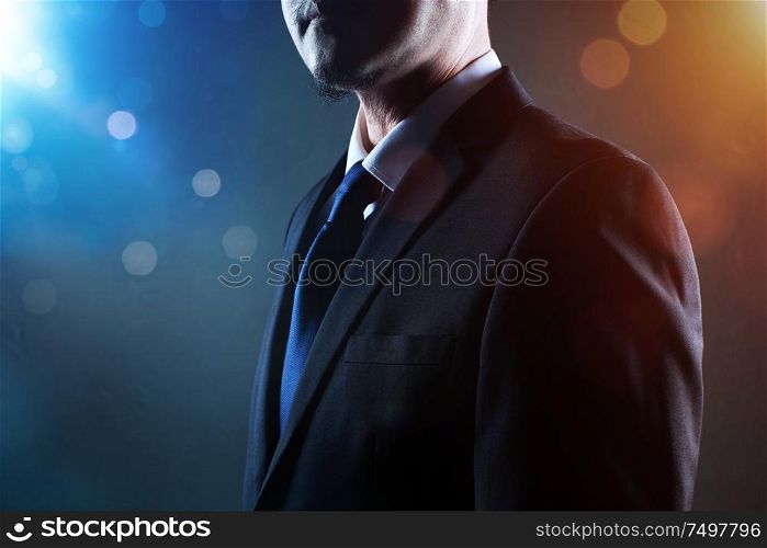 Closeup business man with crossed arms with bokeh and light flare effect apply .