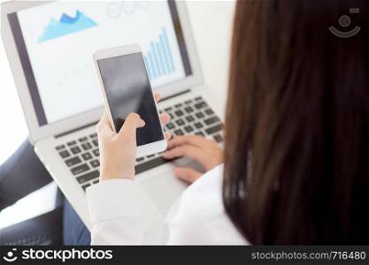 Closeup business woman work with finance analysis and planing data on laptop, girl holding smart mobile phone and typing and looking graph with computer statistic for success, business concept.