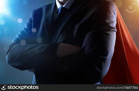 Closeup Businessman in suit and cape hero with crossed arms . bokeh and light flare effect apply .